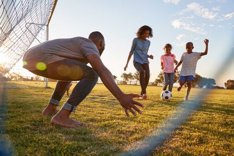 family playing soccer