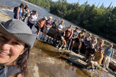 people posting for a picture at a waterfall