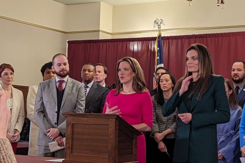 benson with a lot of people in the background at a press conference