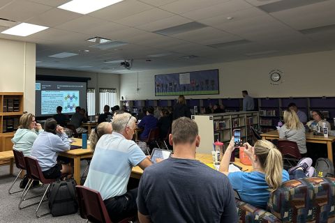 teachers sitting at tables 