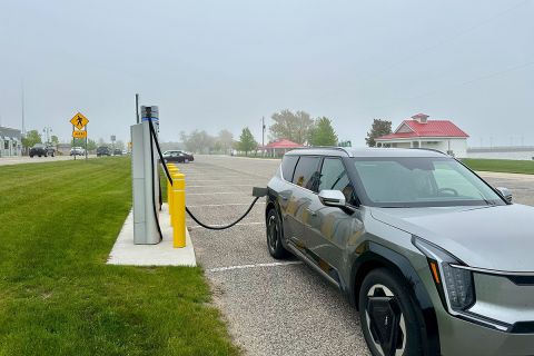 A grey car being charged 