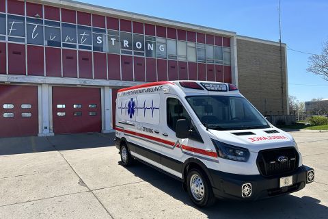 An ambulance parked in front a fire station 