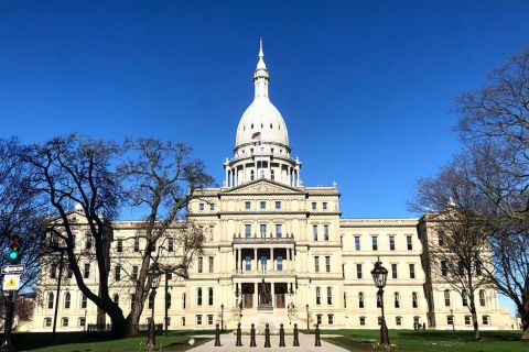 The outside of the Michigan capitol building on a sunny day