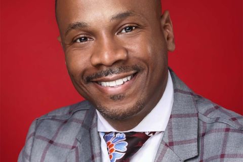 Rev. Richard R. White III wearing a colorful suit and tie