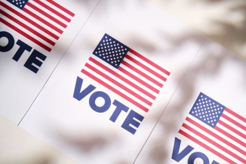 white vote signs that features an American flag