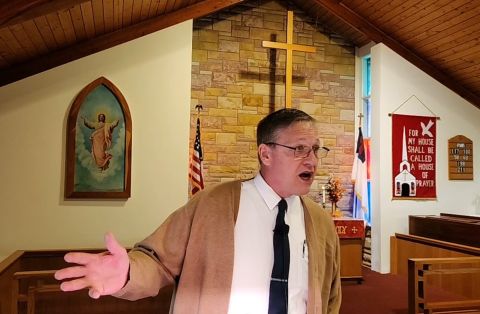 Rock River Township Clerk Tom Schierkolk in front of a church