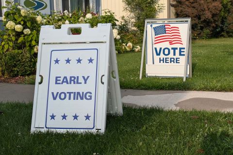 Sign for early voting, a vote here in the background