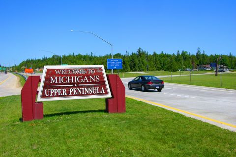 Highway sign welcomes tourist to Michigan's Upper Peninsula