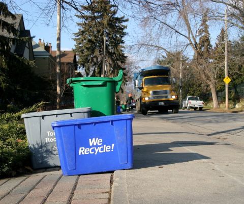 Trash truck and recycling bins on the curb