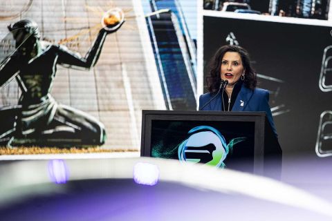 Michigan Gov. Gretchen Whitmer speaks at a podium at the Detroit Auto Show