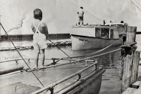 A historical photo of two boys fishing. 