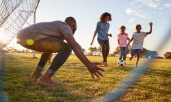 family playing soccer