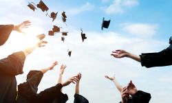 graduation hats being thrown up to air