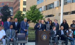 Judge William McConico speaking at a microphone during press conference