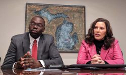 Michigan Gov. Gretchen Whitmer and Lt. Gov. Garlin Gilchrist sitting at a table