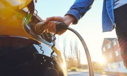 person charging electric car