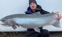 Man holds fish.