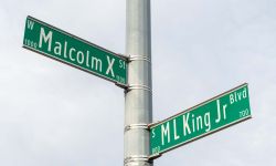 Street signs for Martin Luther King Jr and Malcolm X. Civil rights leaders in Lansing Michigan