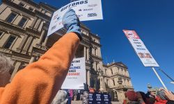 People hold up signs at gun rally