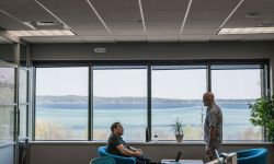 an open space office. In the window, you can see Grand Traverse Bay