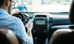 Man texting on phone while driving