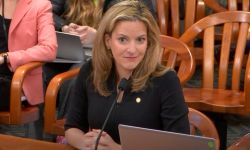 Secretary of State Jocelyn Benson sits at a desk