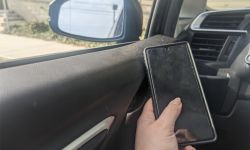 person holding cell phone in car