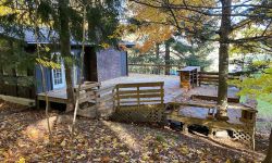 a home with a large deck surrounded by deck 