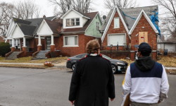 Two people walk toward a house