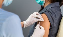 close up doctor holding syringe and using cotton before make injection to patient in medical mask.