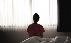 woman sitting alone in a bed