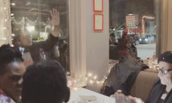 Protestors stand outside restaurant