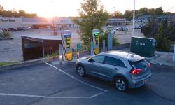 Electric car charging at a ChargePoint DC fast charger at sunset