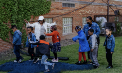 students outside playing with a teacher