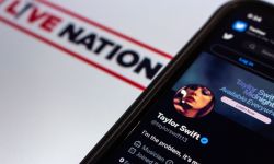 Phone screen shows Taylor Swift's X (formerly known as Twitter) profile on top of Live Nation flyer