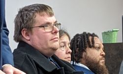 Man sits at a hearing