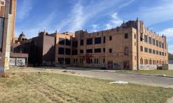 vacant Cooley High School. The building has graffiti on the side