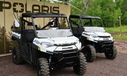 Two white, electric off-road vehicles 