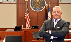 Ingham County Prosecutor John Dewane standing in a courtroom 