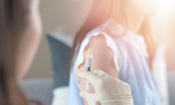 Woman having vaccination with syringe by nurse