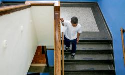 A boy walking down the stairs