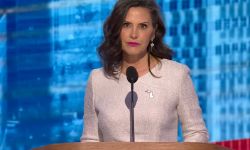 Michigan Gov. Gretchen Whitmer, wearing a white dress, speaks at the DNC in Chicago