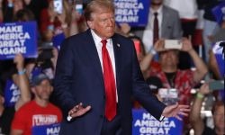 Donald Trump stands on stage at a rally