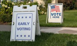 Sign for early voting, a vote here in the background