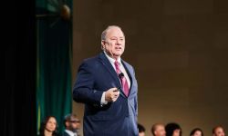 Mayor Mike Duggan, wearing a blue jacket, on the stage