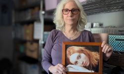 Woman holds a photo of her daughter