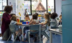 A teacher in a classroom with her students 