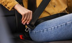 Woman buckles seat belt