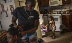 A mom and her daughters in the kitchen 