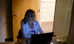 A woman working at a computer. 